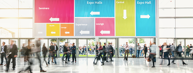 image of people walking inside the lobby of a trade show event