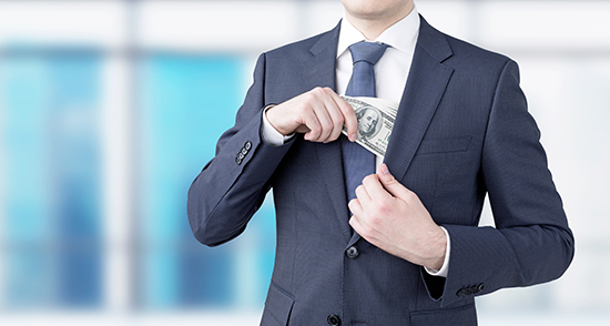 image of man in suit putting money into the inside chest pocket of his jacket