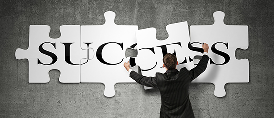 image of man putting together puzzle pieces that spell success