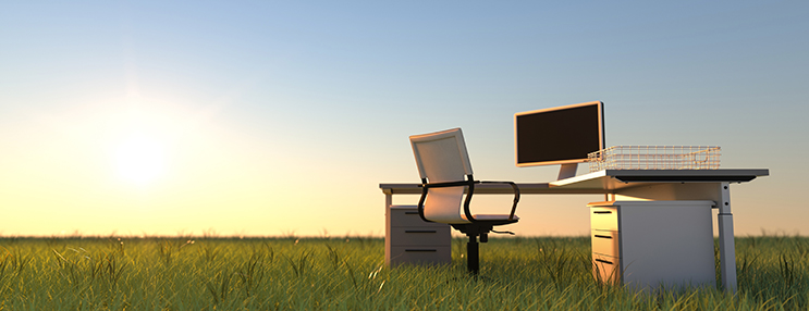 photo of office desk in the middle of a field