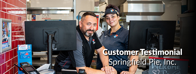 photo of Springfield Pie Inc employees smiling and welcoming you to their Domino's location