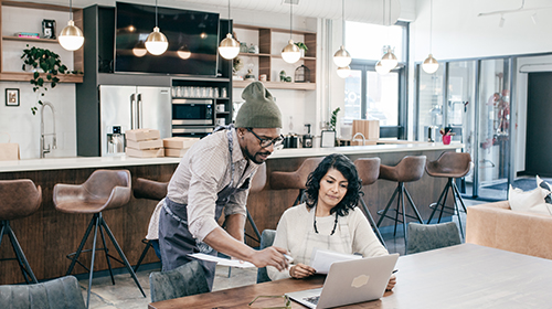 male coffee shop owner working with tax advisor in his business