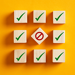 Blocks with green checkmarks forming a square on a yellow background
