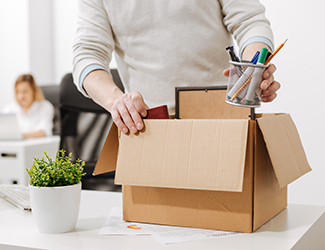 image of employee packing his desk to leave company