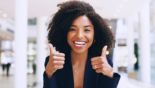 photo of happy woman giving two thumbs up
