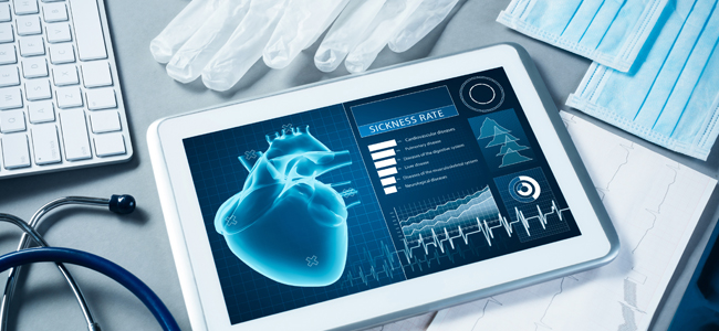 photo showing tablet with heart diagnostic image on desk surrounded by other medical devices