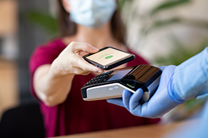 woman paying with contactless scanner