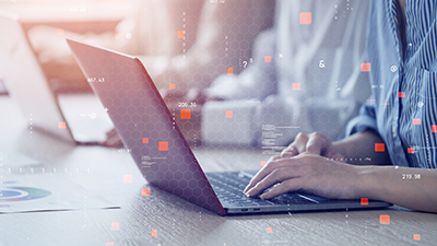 photo of woman using laptop to access cloud technologies