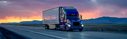 tractor-trailer-on-divided-higway-at-nightfall