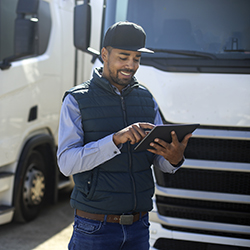 truck driver logging daily receipts on tablet