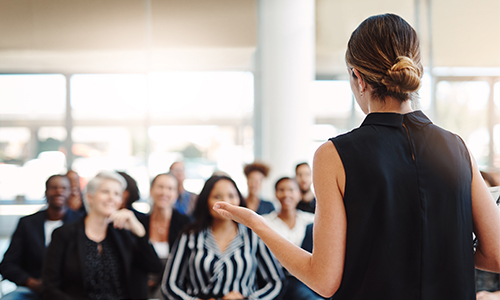 business woman giving presentation to other business people