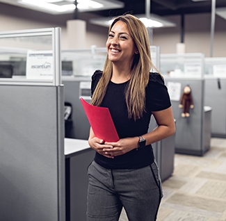 photo of smiling woman walking down hallway at work