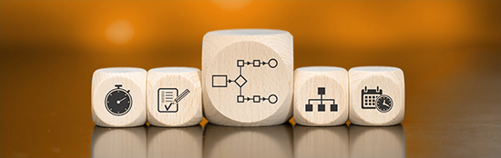wooden blocks showing icons that conceptualize SMB expense efficiencies